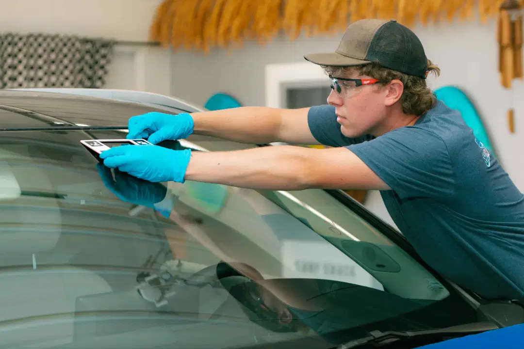 AGRSS certified windshield repair technician working on vehicle safety